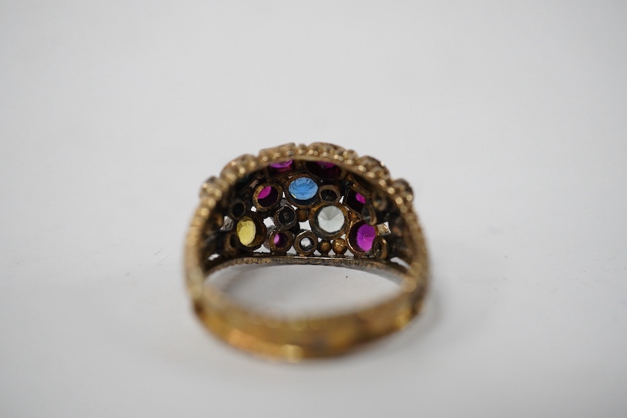 A 1940's continental yellow metal and multi gem set cluster dress ring, size P, gross weight 6.6 grams. Condition - poor to fair